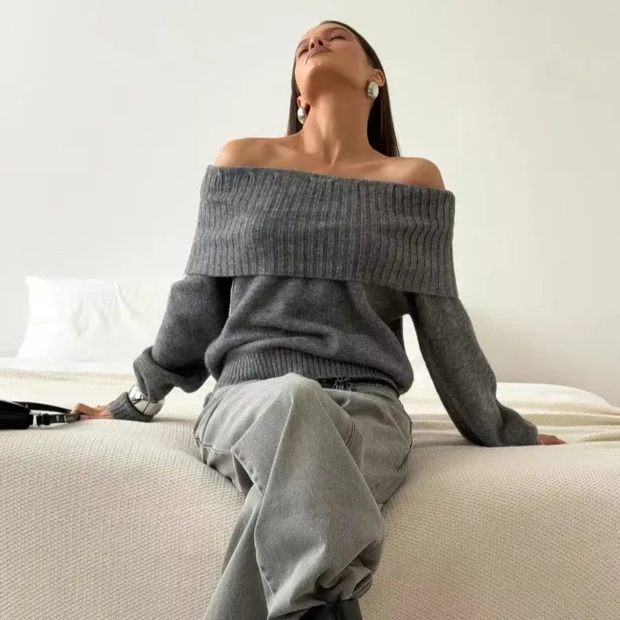 Grey off-the-shoulder sweater with a 3D textured pattern and strapless design.