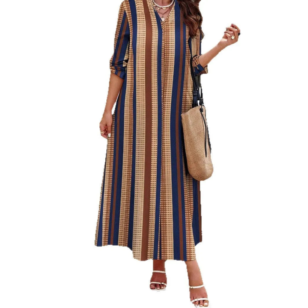 Camel coloured women's long dress with vertical stripes, V-neck, and long sleeves.