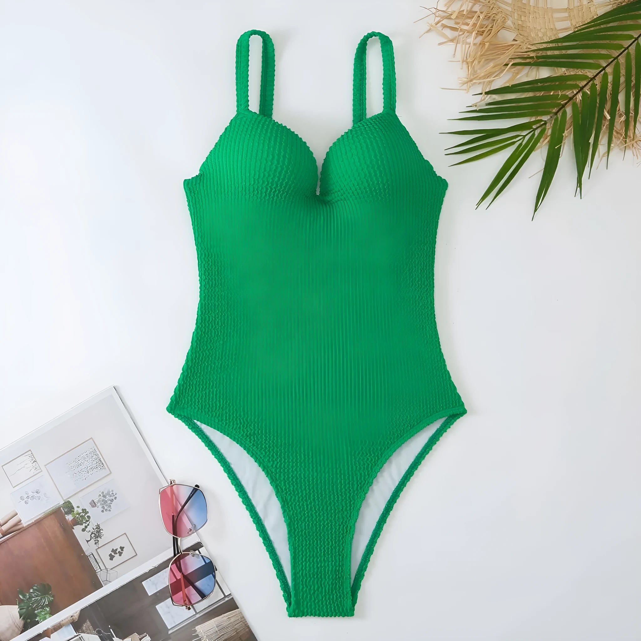 A women's sleeveless one-piece swimsuit on a hanger, shown in black, with other colour options available.