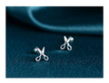 A pair of S999 pure silver screw-back ear studs featuring a decorative mini scissors design.