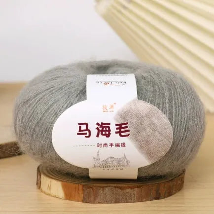 DIY mohair scarf weaving kit showing one wool ball and a selection of 34 colour options including white, pink, blue and green.