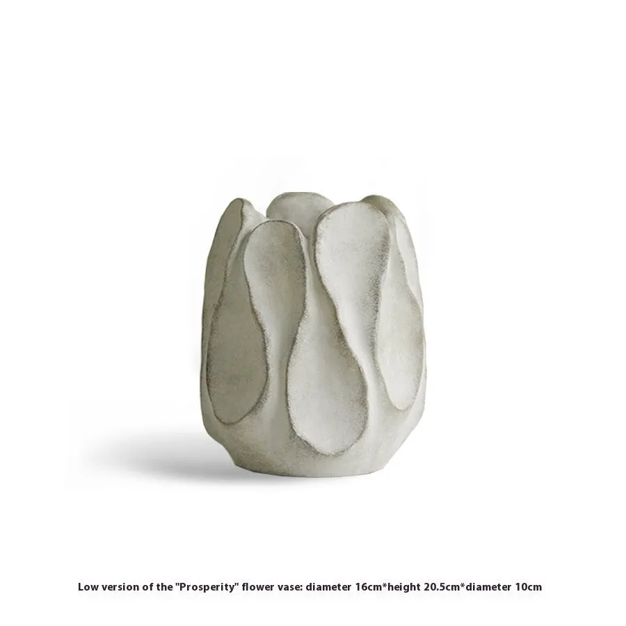 Handmade irregular ceramic vase in magnesium clay on a wooden surface.