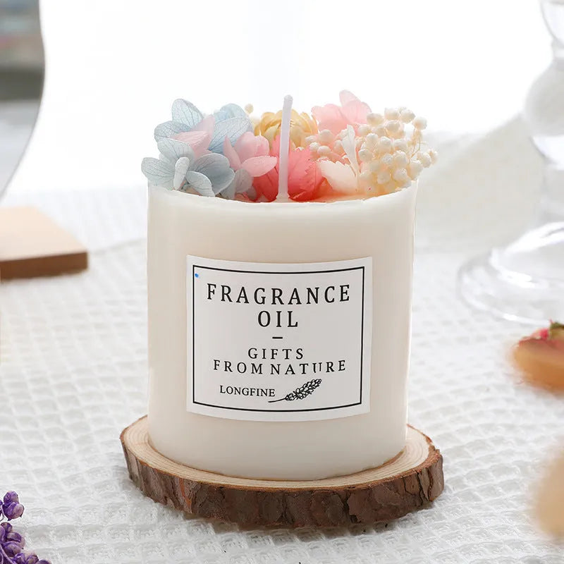 Decorative aromatherapy candle with dried flowers embedded in solid wax, shown with optional wooden chip base.