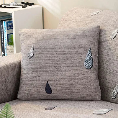 Printed stretch sofa cover with geometric pattern on three-seater sofa