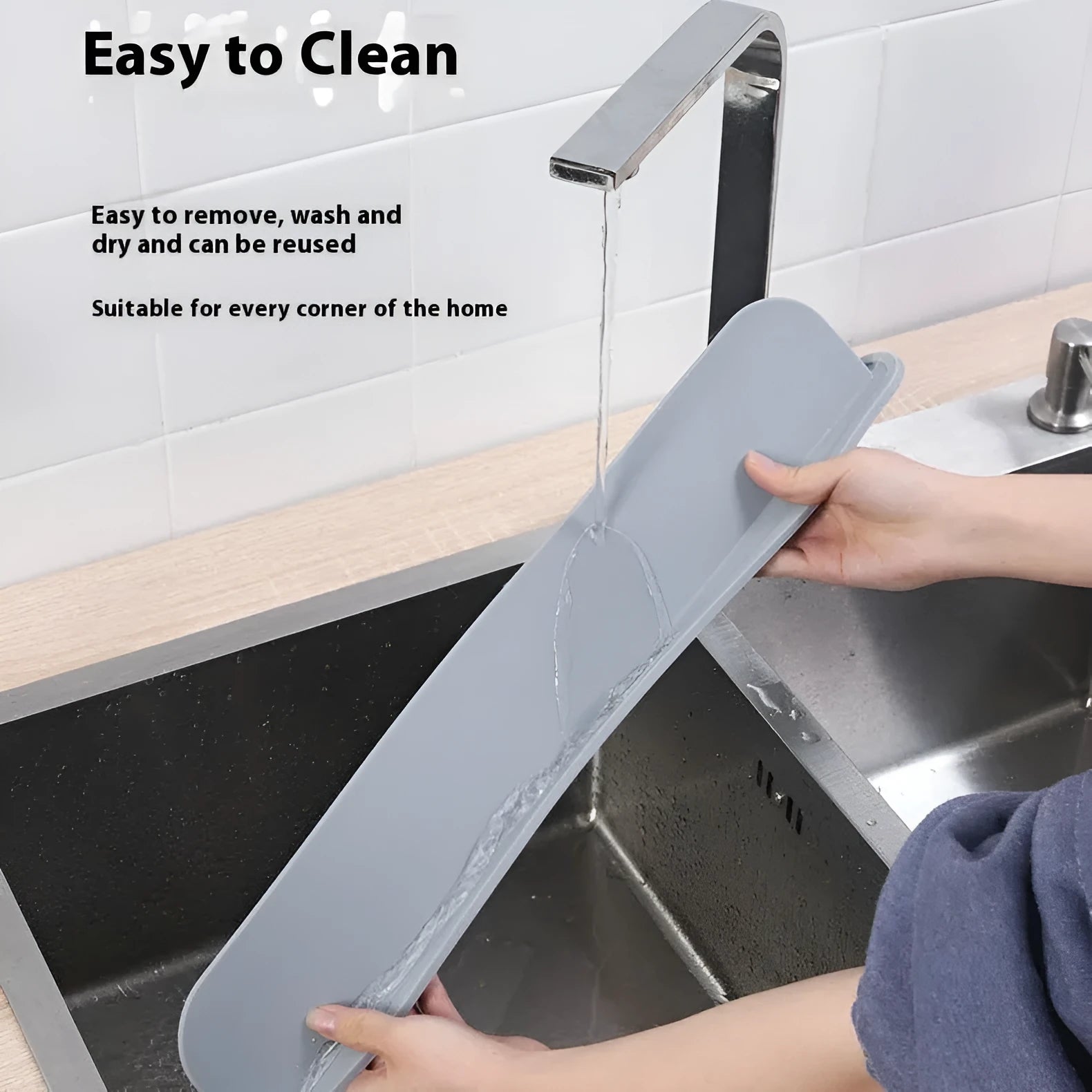 Thick grey silicone kitchen sink water blocking plate sitting on a counter next to a sink