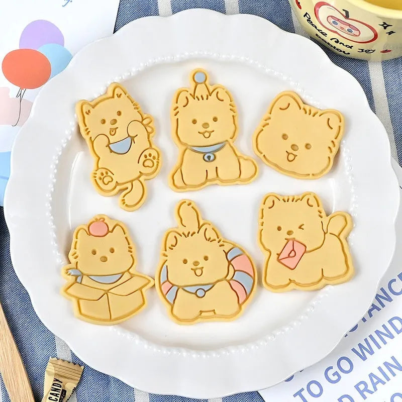Three dimensional plastic biscuit mould showing puppy cartoon designs including birthday hats and swimming rings