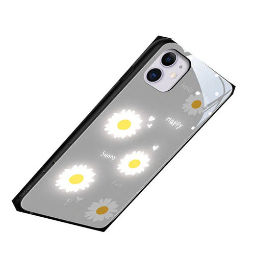 White luminous iPhone case with purple daisy design and voice-activated colour light on a table.