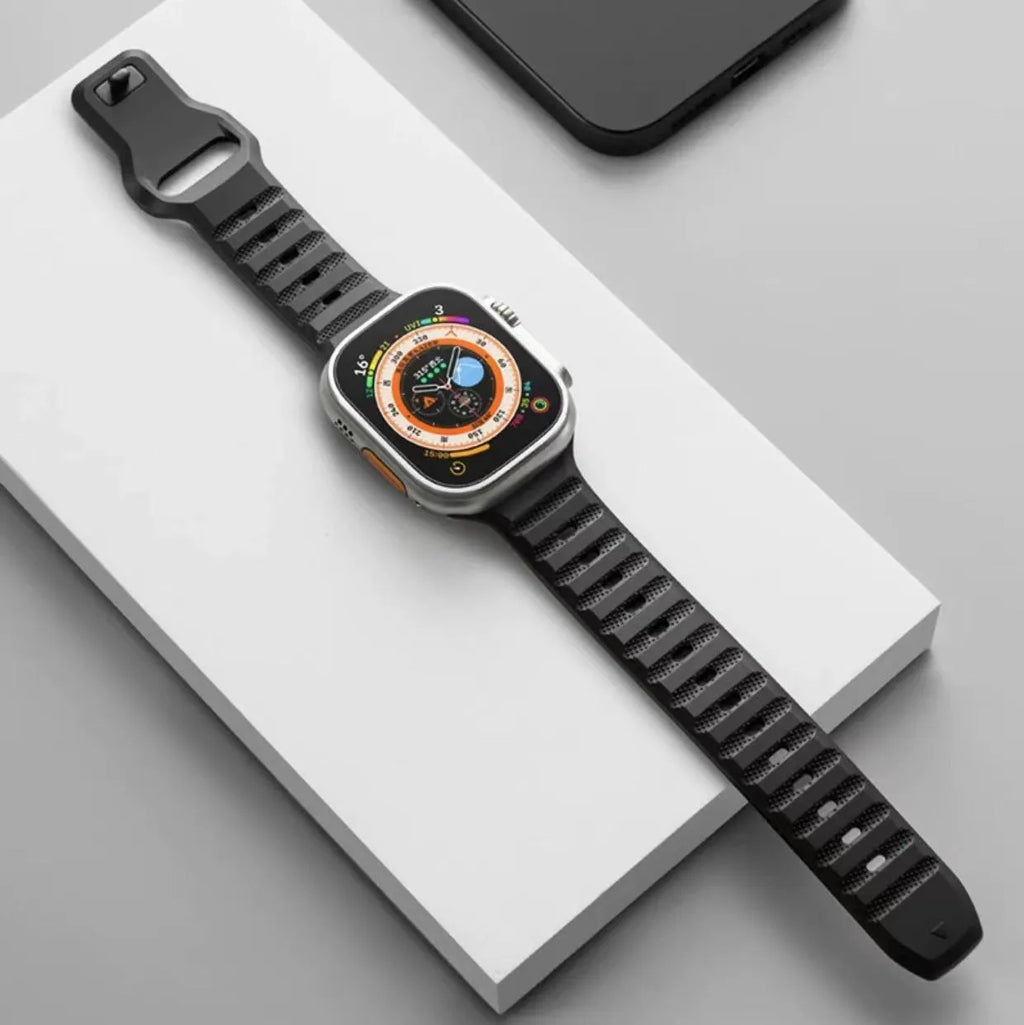 Fluoro rubber Apple Watch band with T-buckle in multiple colours on a grey background