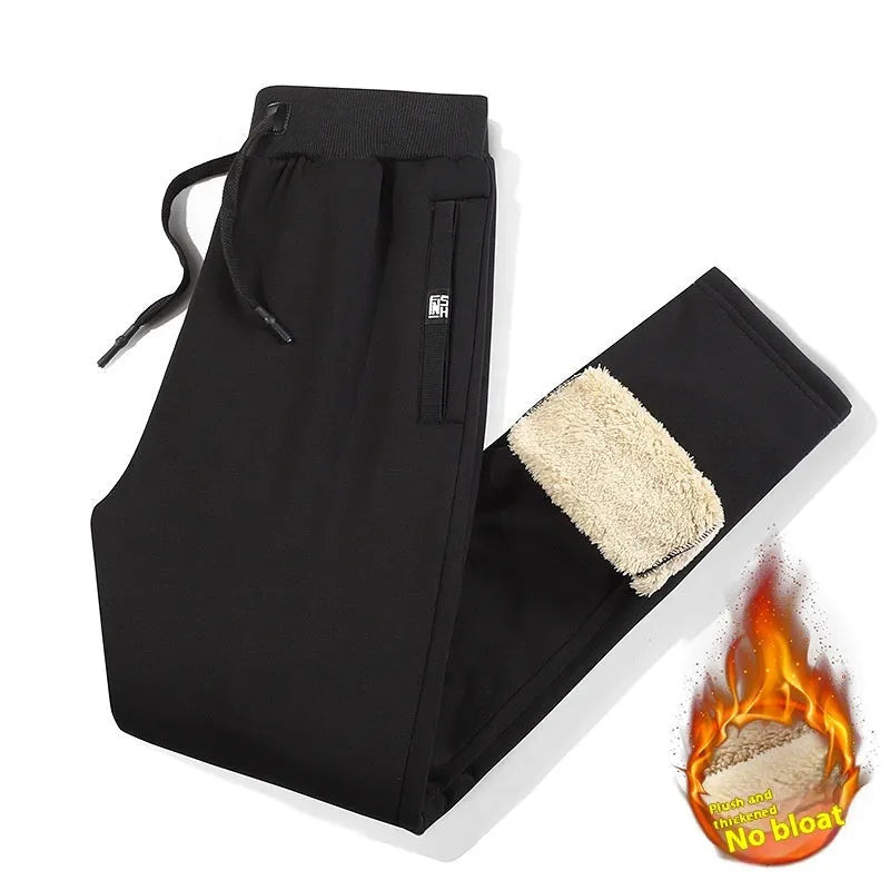 Men's grey oversized fleece-lined cotton track pants with drawstring waist on a hanger.