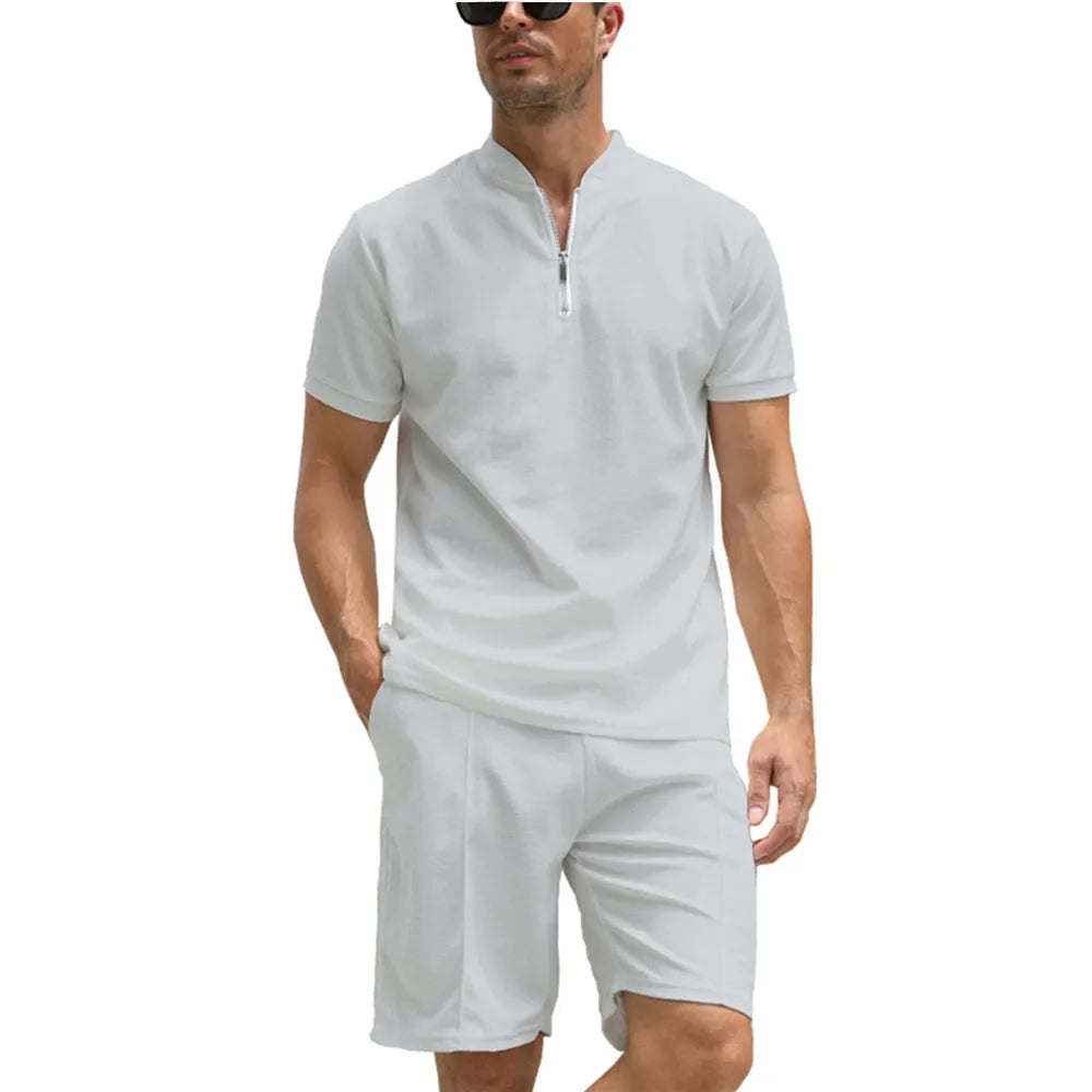 Men's solid colour short sleeve polo shirt and matching trousers two-piece set on a hanger.