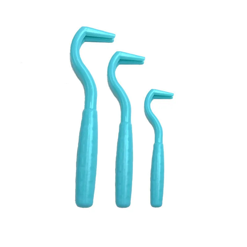 Set of three coloured ABS plastic tick removal hooks for dogs on a white background.
