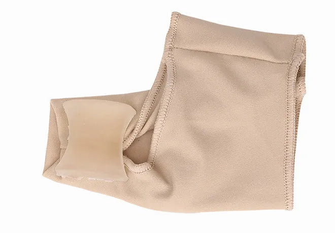 Corrective toe socks with silicone gel bunion pad and toe separator on a foot.