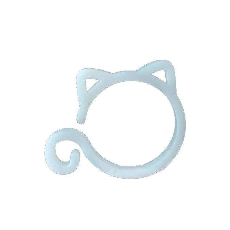 Red cat-shaped plastic gardening clip for plant support on green leaves