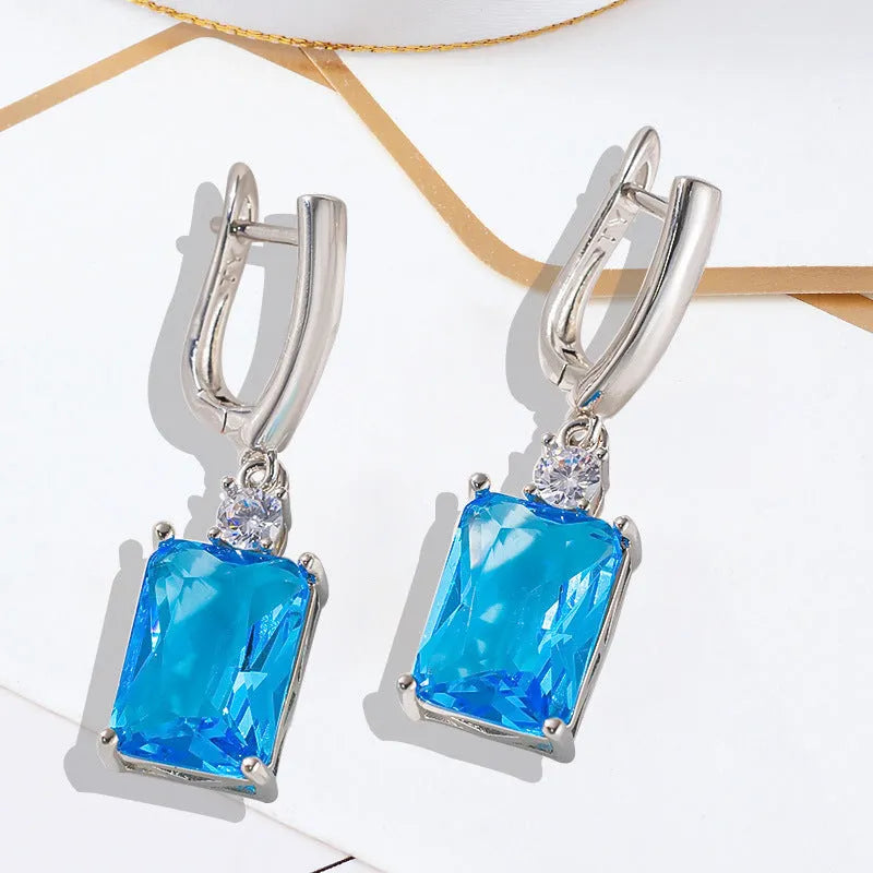 Square geometric copper earrings with gold or silver electroplated finish showing quadrilateral shape.