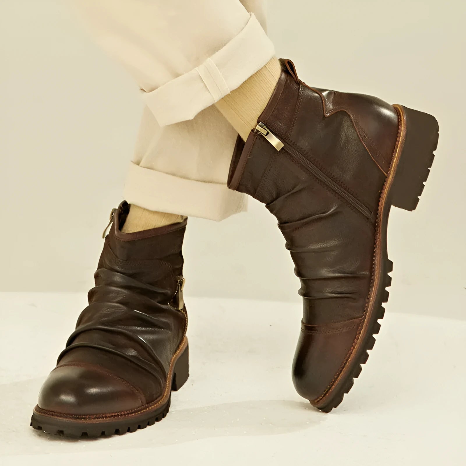 Brown mid-calf cowboy boots with a side zipper, round toe, and a medium horseshoe heel.