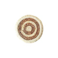 Round natural papyrus placemat with corn rope tassel trim on a wooden table.