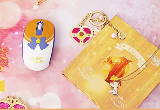 Pink Sailor Moon wireless mouse with USB receiver showing character graphics and three-button design
