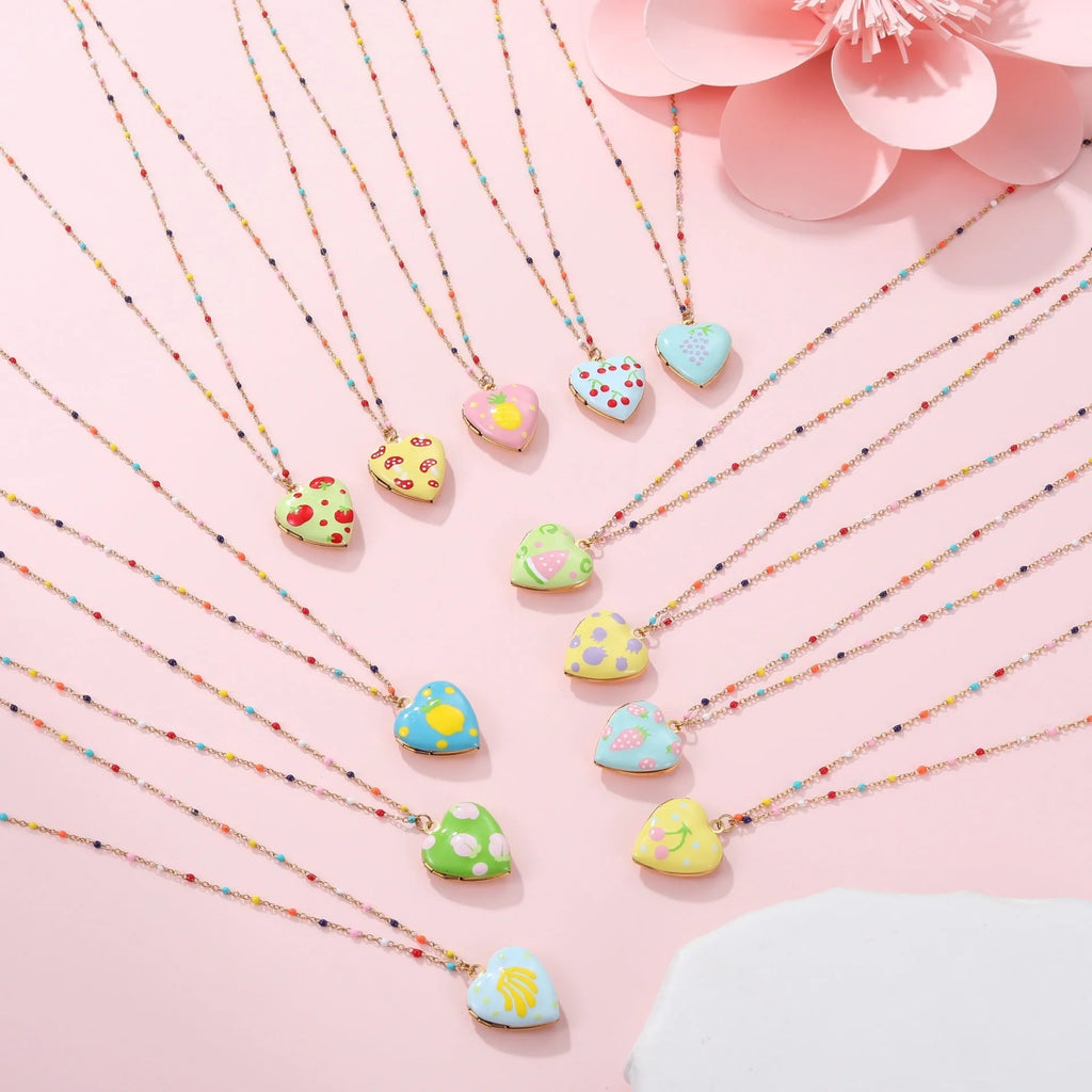 Women's stainless steel necklace with gold plating showing heart-shaped fruit pendant design on adjustable chain
