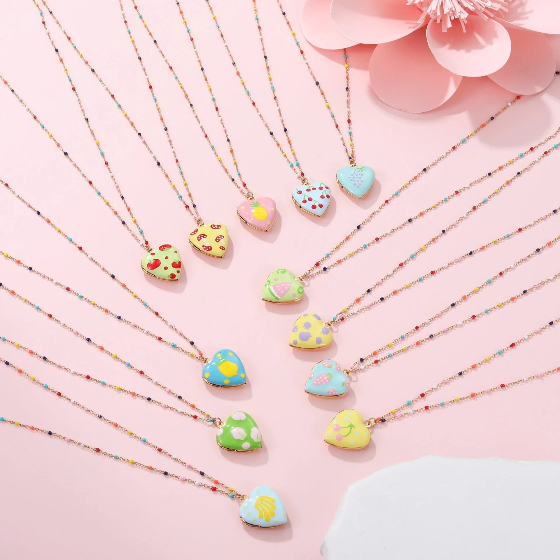 Women's stainless steel necklace with gold plating showing heart-shaped fruit pendant design on adjustable chain