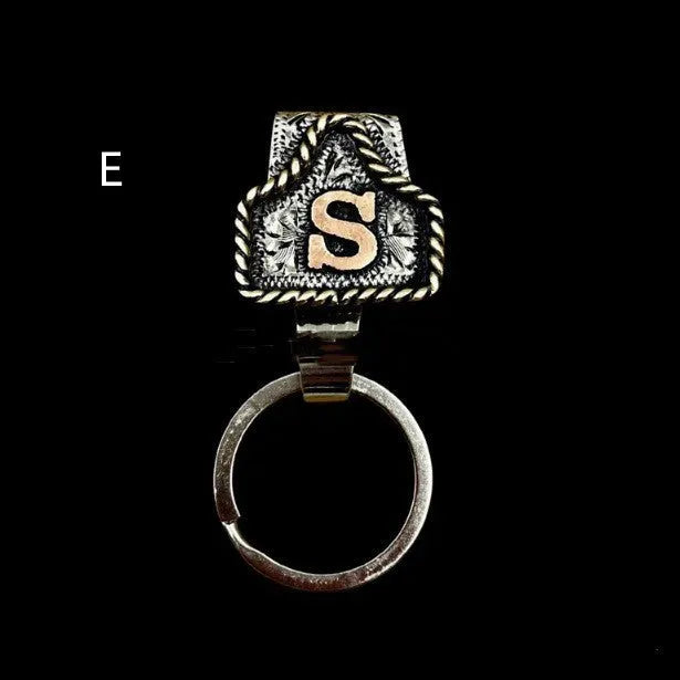 Handmade metal cow tag belt key holder keychain on a key ring, showing the metal loop and tag design.