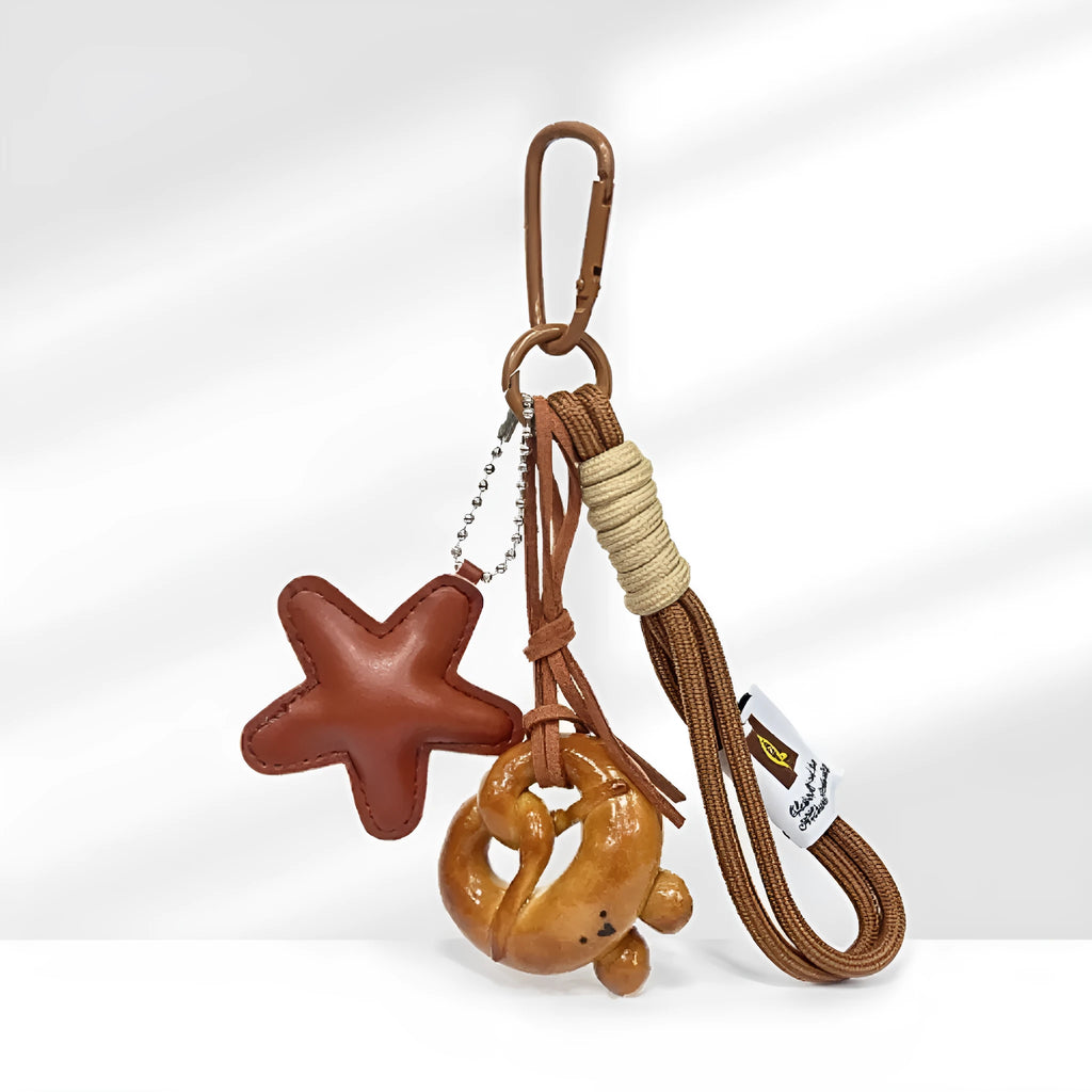 Handmade brown polymer clay soda bread charm on a brown strap, showing cartoon bread design details.