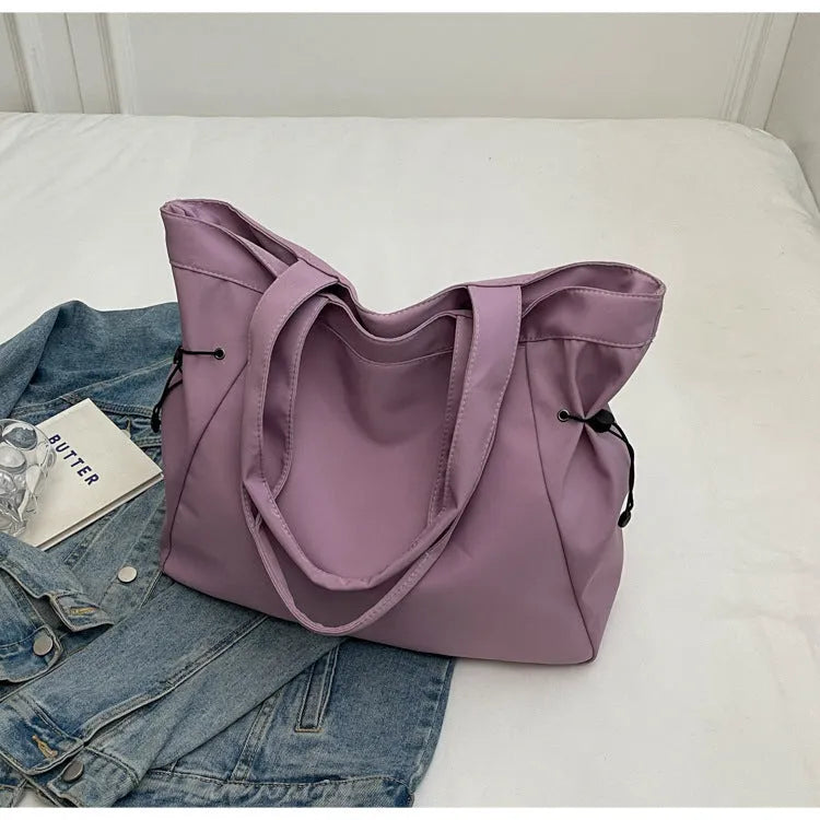 Soft Oxford cloth foldable commuter tote bag in street style, shown in multiple colour options.