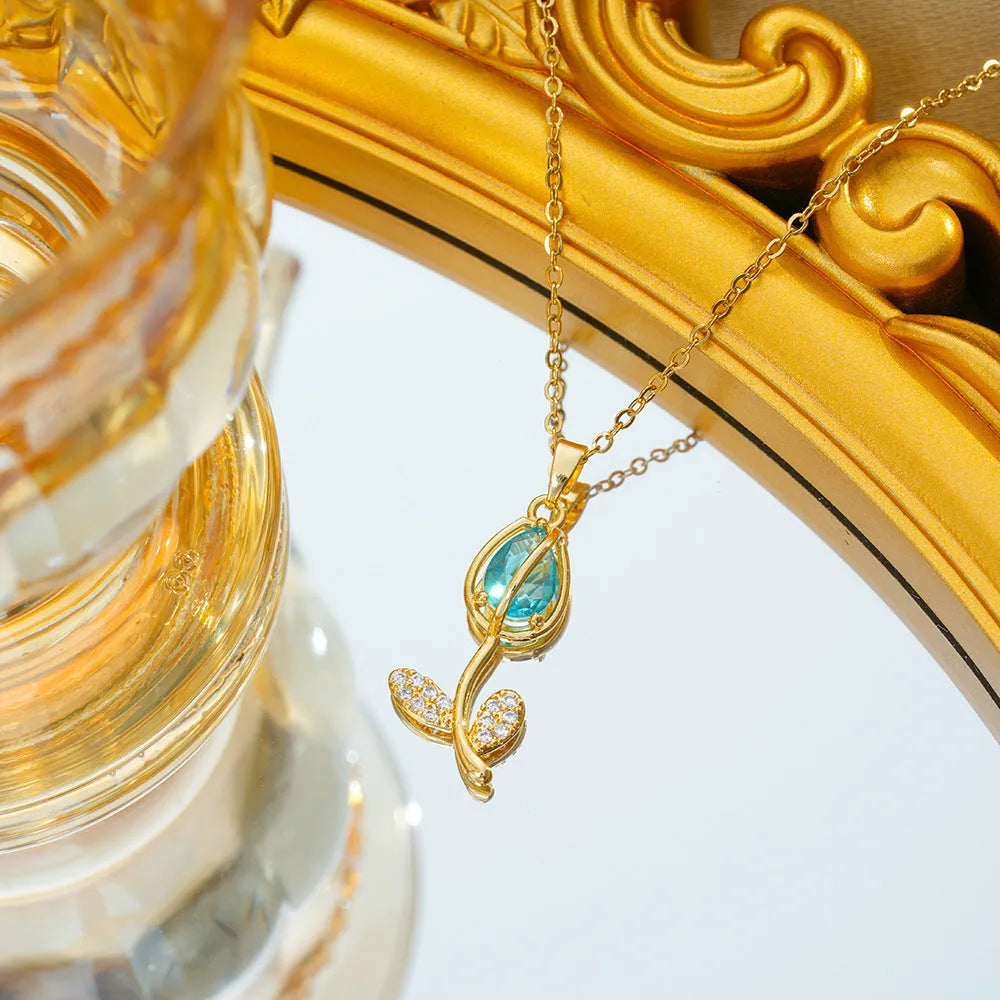 Gold electroplated tulip flower pendant on an adjustable titanium steel necklace chain.