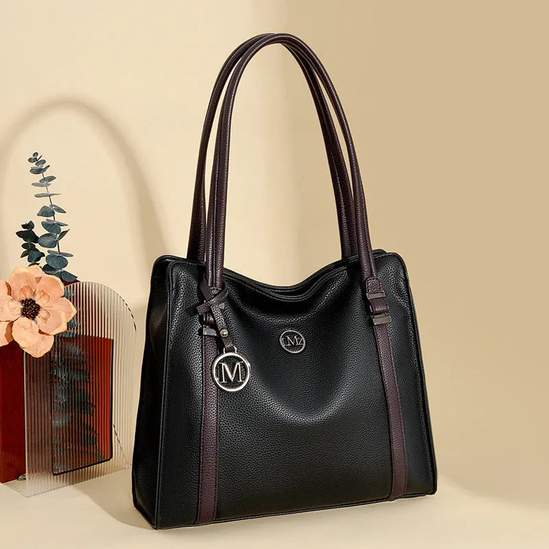 Woman holding a large soft black PU leather retro crossbody bag with double shoulder straps.