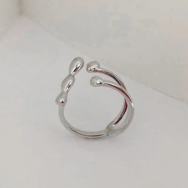 Brass opening ring with spherical design elements in gold finish