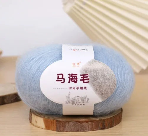 DIY mohair scarf weaving kit showing one wool ball and a selection of 34 colour options including white, pink, blue and green.