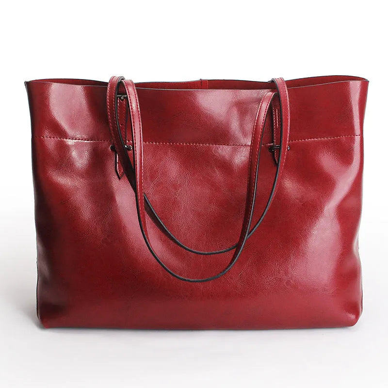 Cowhide leather cross-body handbag showing internal compartments and mobile phone pocket