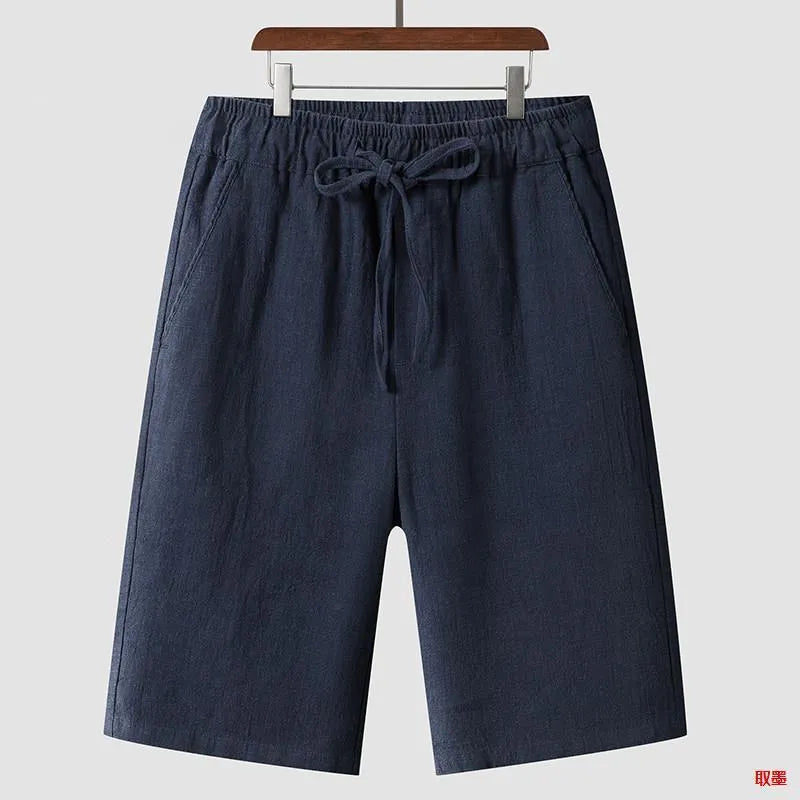 Man wearing beige linen cropped shorts with a loose fit and elasticated waist