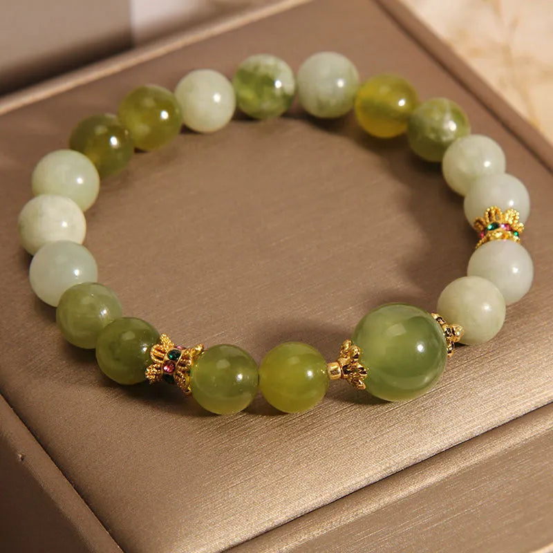 Women's bangle bracelet made from green Xiuyan jade stone with an original design.