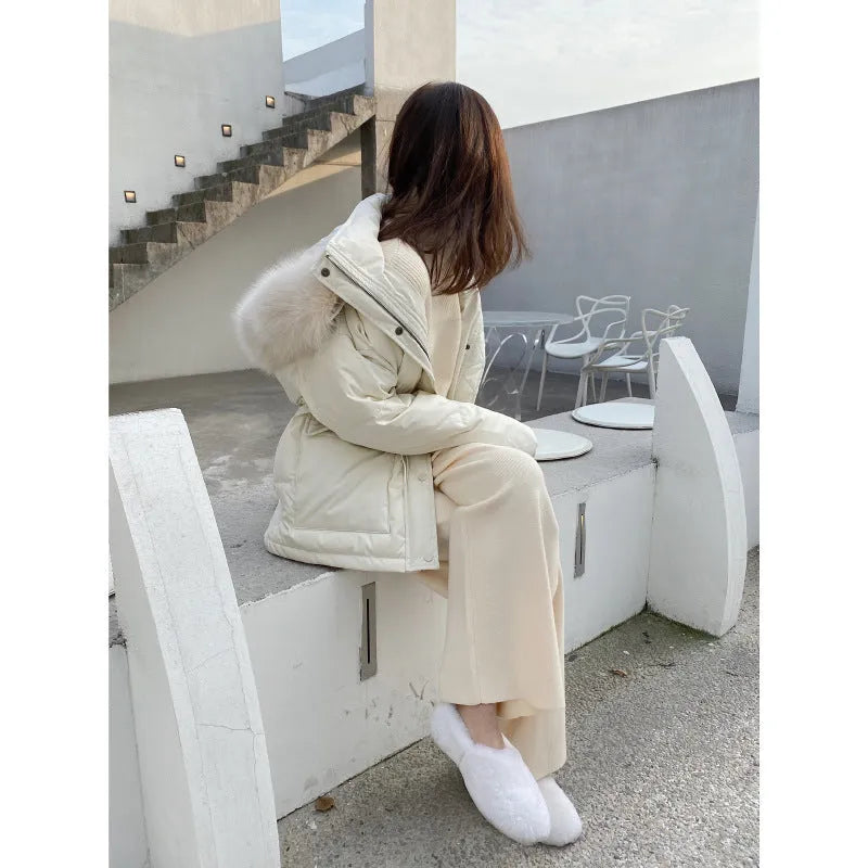 Women's high waist wide-leg knit trousers in cream white colour, laid flat to show straight-leg cut.