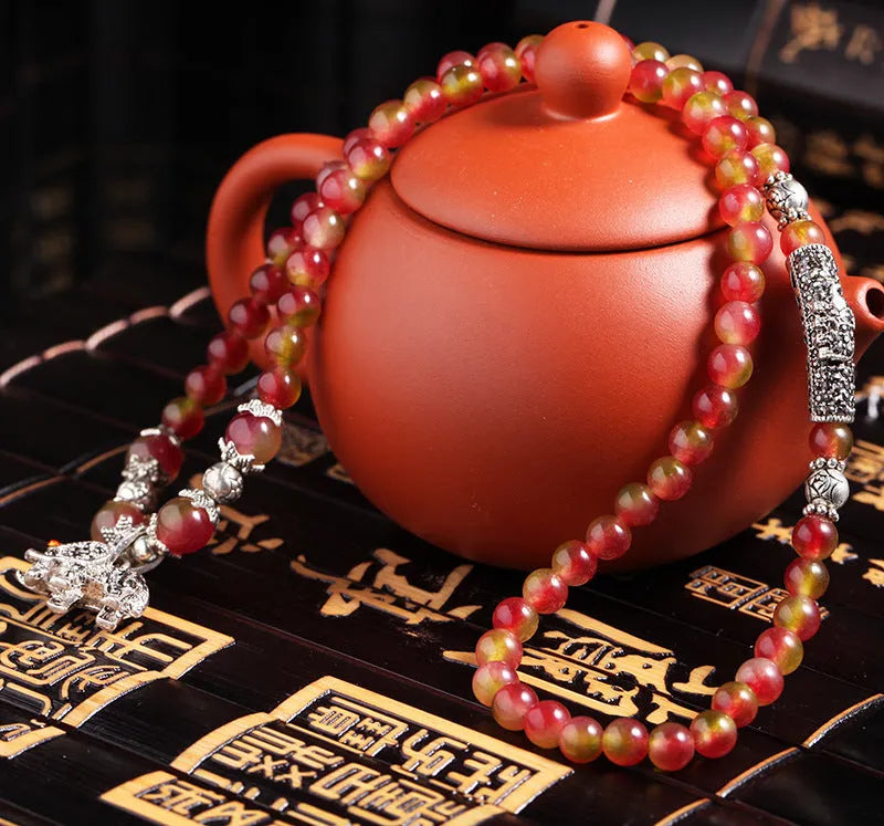 Watermelon crystal bracelet with Chinese knot detailing in geometric national style design