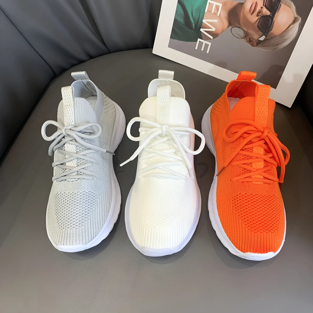 Women's cream running shoes with breathable mesh upper and flat rubber sole