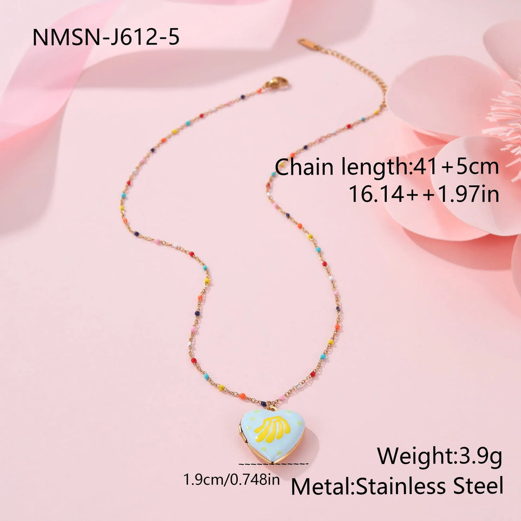 Women's stainless steel necklace with gold plating showing heart-shaped fruit pendant design on adjustable chain