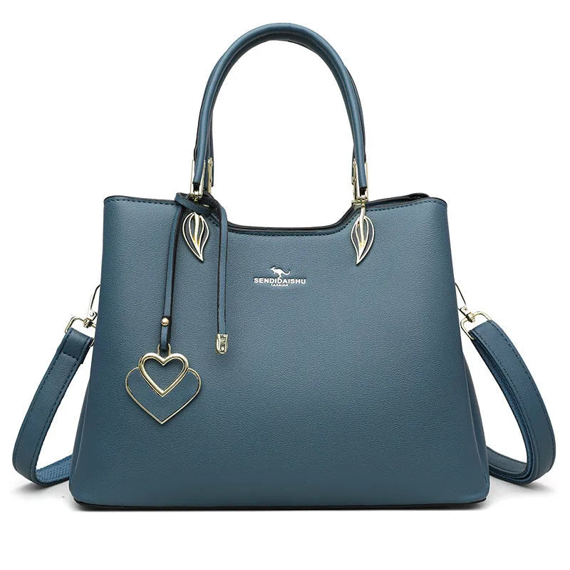 Women's black PU messenger bag with multi-layer design and visible sewing thread detail.