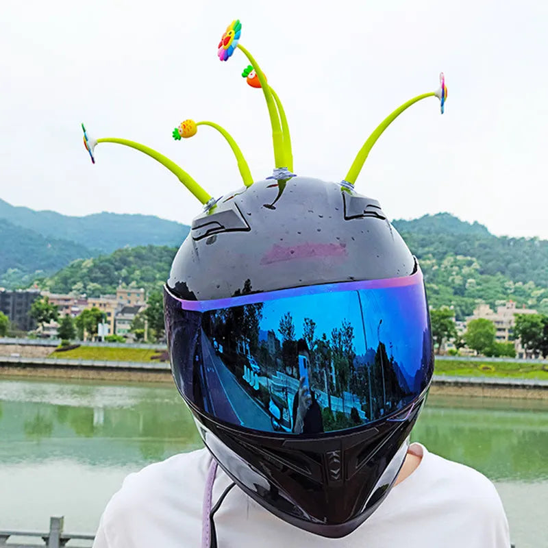 Yellow silicone sunflower decoration with suction cup for attaching to a helmet.
