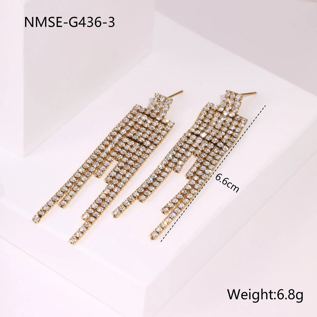 Gold plated stainless steel earrings with love heart and star geometric shapes and diamond tassel details