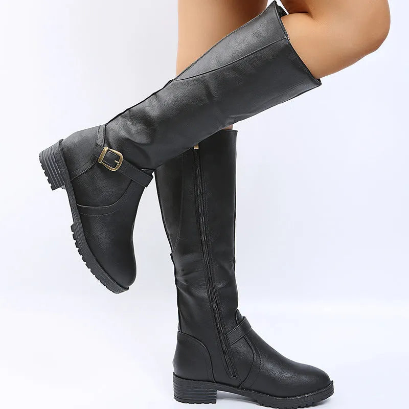 Women's black knight high boots with a square heel, round toe, and a belt buckle detail on the upper.