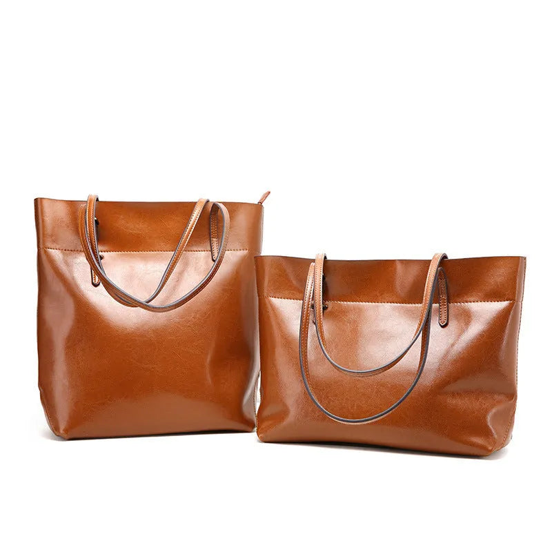 Cowhide leather cross-body handbag showing internal compartments and mobile phone pocket