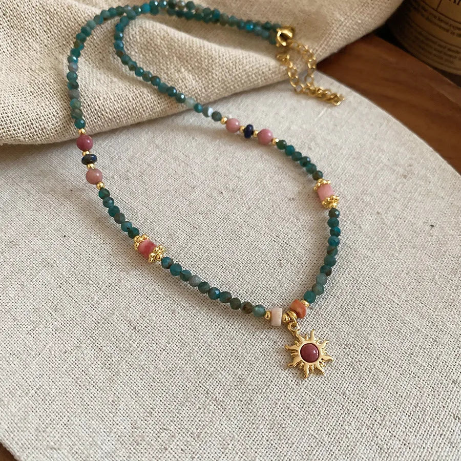 French royal style necklace with sun pendant, freshwater pearls, and adjustable metal chain.