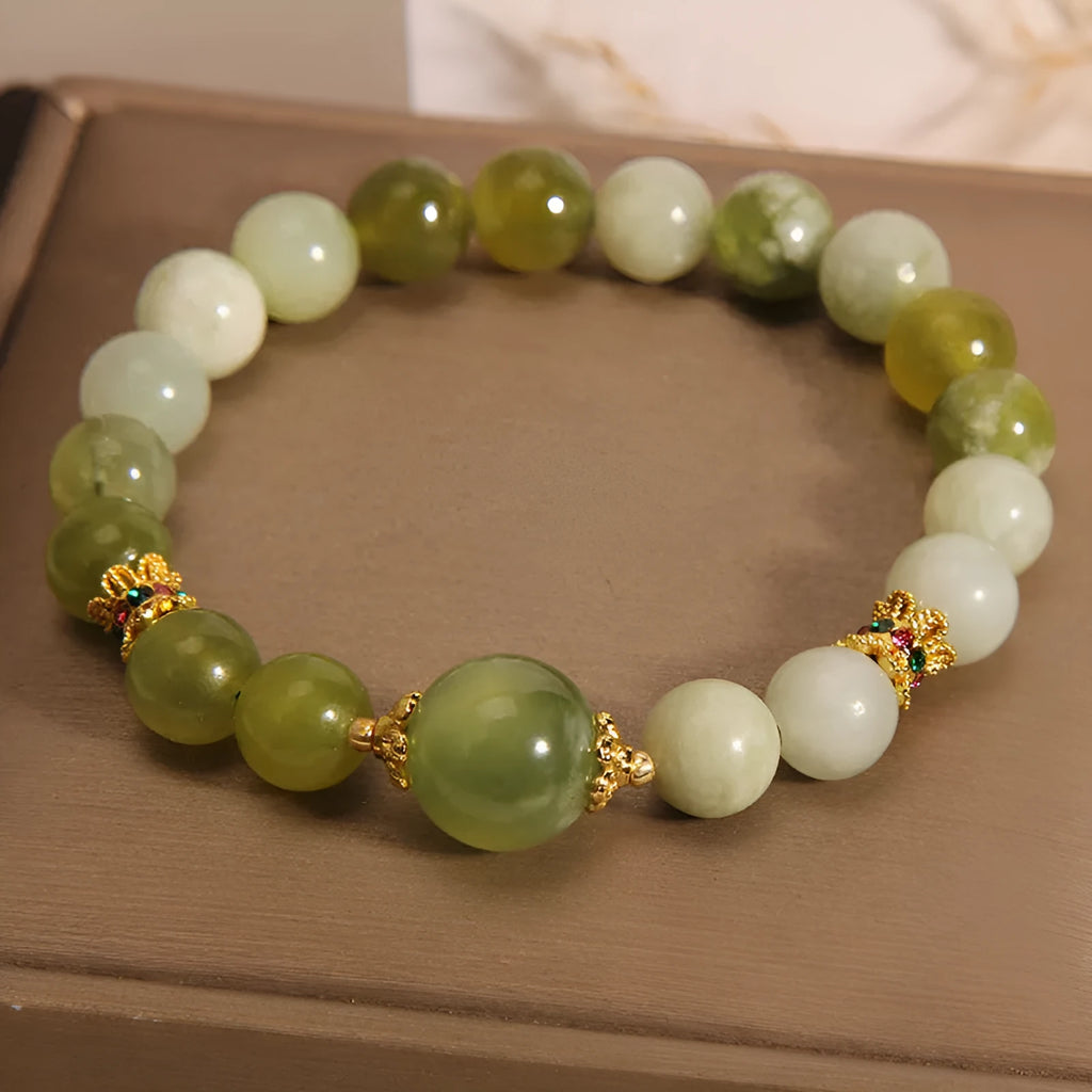 Women's bangle bracelet made from green Xiuyan jade stone with an original design.