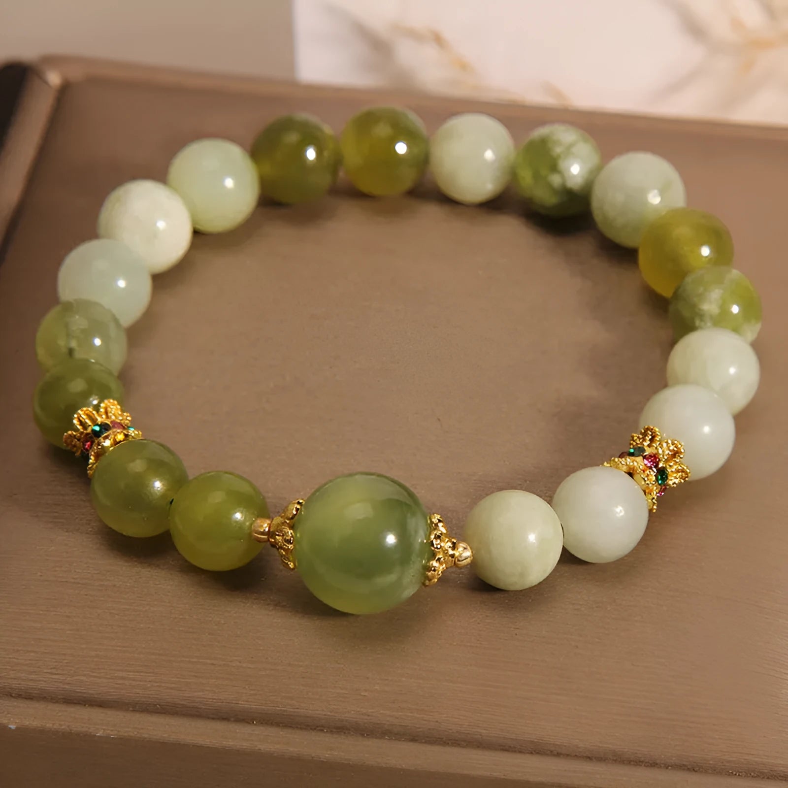 Women's bangle bracelet made from green Xiuyan jade stone with an original design.