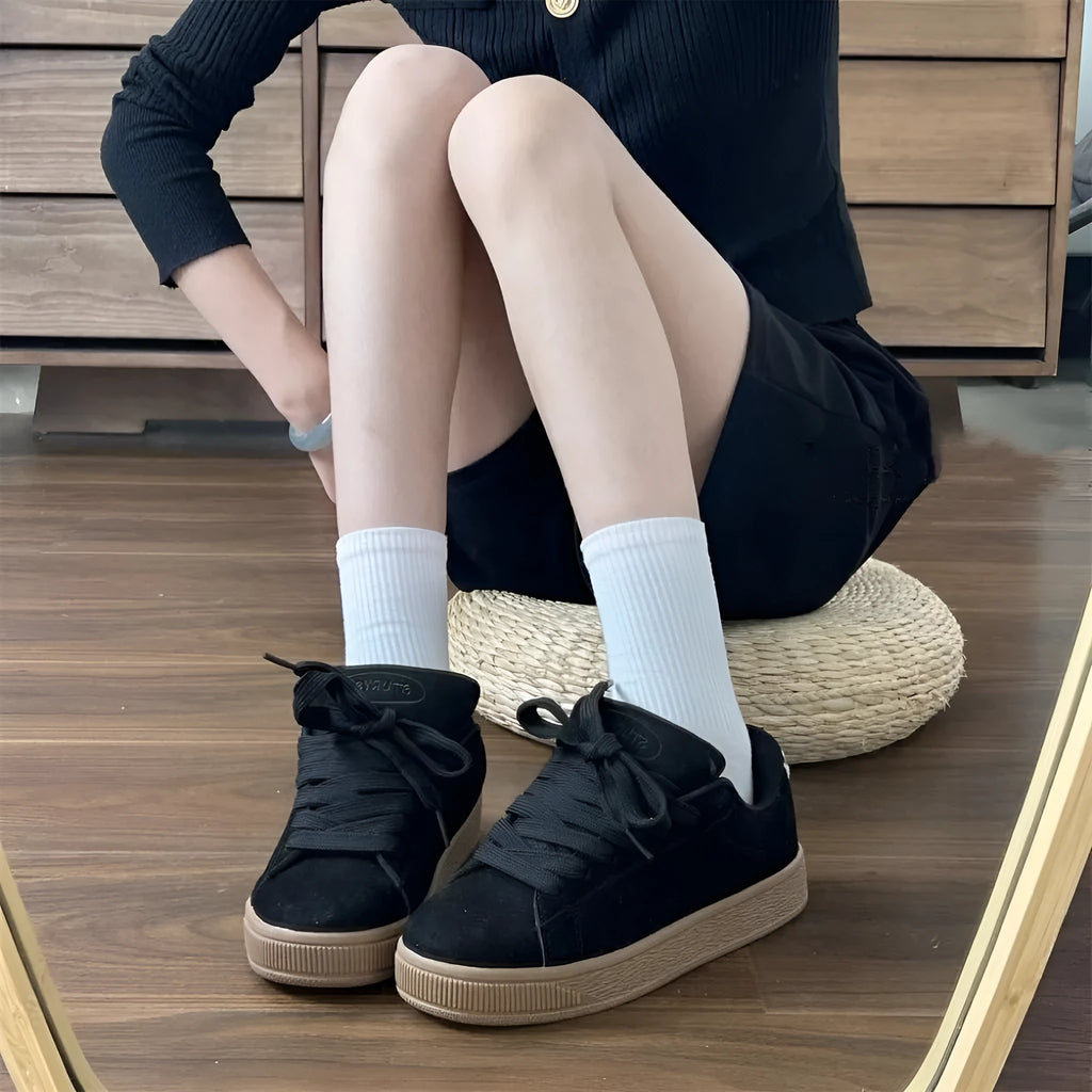 Black retro-style low-top lace-up sneakers with a round toe and waterproof platform sole.