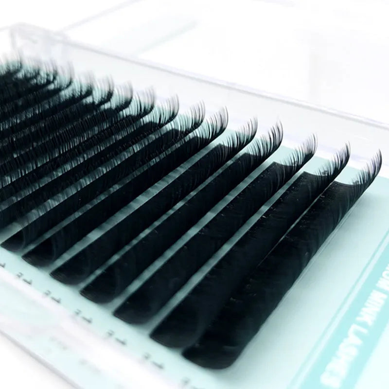 Pair of artificial fibre false eyelashes with soft velvet texture, showing varied curl and length options.
