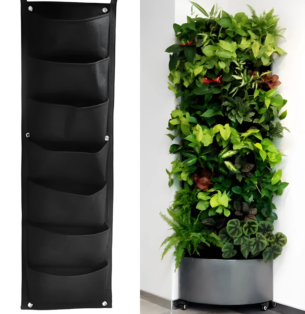 Green recycled felt vertical wall planter with multiple planting pockets hung on a wooden fence.