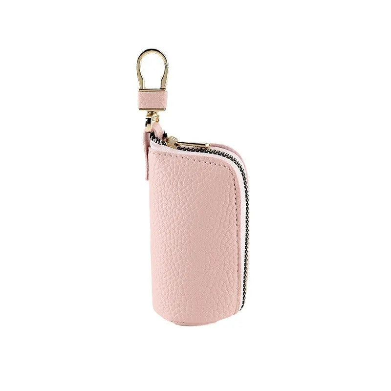 Simple black PU zipper key ring case for car and home keys on a grey background.