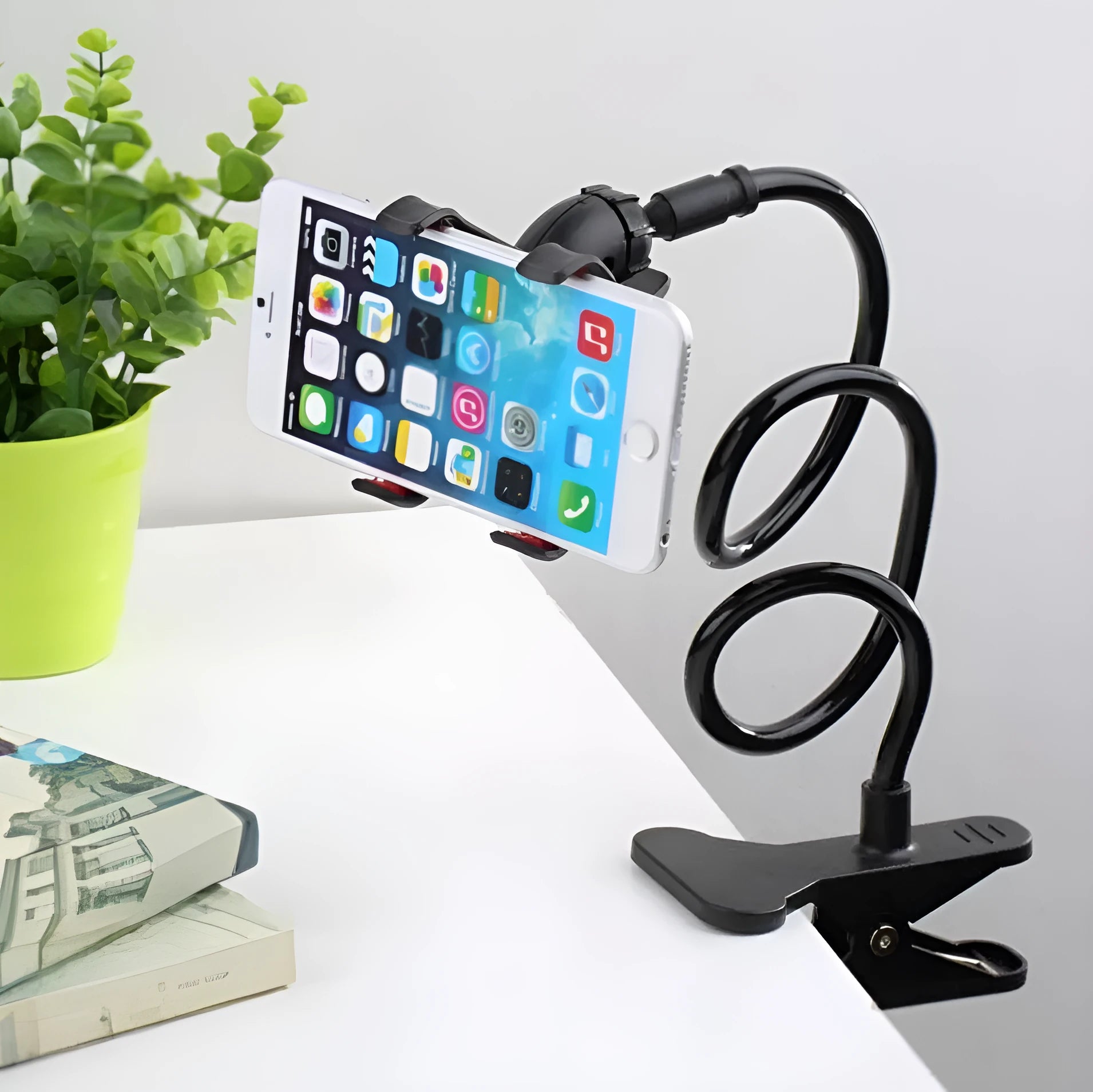 Black portable phone holder with a long 70cm flexible arm and a V-shaped clip mounted on a bed frame.